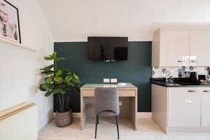 a small kitchen with a desk and a chair at Dublin Central Suites in Dublin