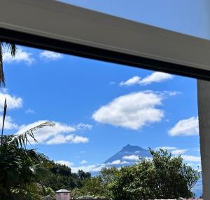 a view of a mountain through a window at UpTown Apartments in Horta
