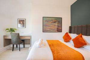 a hotel room with a bed with a desk and a desk at Dublin Central Suites in Dublin +67 photos
