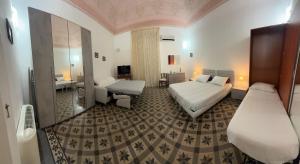 a hotel room with two beds and a bathroom at Crispi Accomodation B&B in Catania