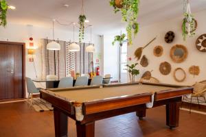 a pool table in a room with chairs at WOT Sarrazola Soul in Sintra