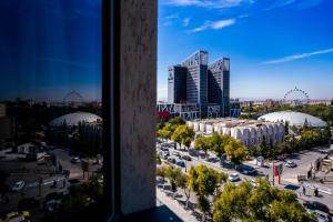 a view of a city from a window at Rénéa Hotel in Sétif