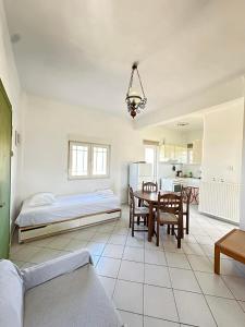 a living room with a bed and a table and chairs at Casa Limoni in Preveza