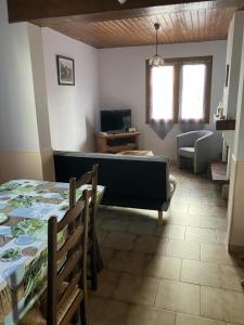 a living room with a couch and a table in a room at Tastet in MouscardÃ¨s