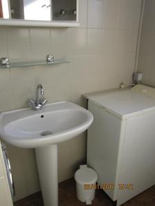 a bathroom with a white sink and a toilet at Tastet in MouscardÃ¨s +9 photos
