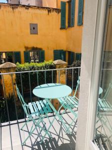 a table and chairs sitting on a balcony at Casamea - Studio, Terrasse, Clim, Centre hist in Ajaccio