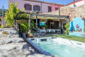 a hot tub in the yard of a house at S'Asilo Boutique B&B - North Sardinia - Village stay in Banari