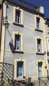 a building with windows and a table in front of it at Les florentines in Carcassonne