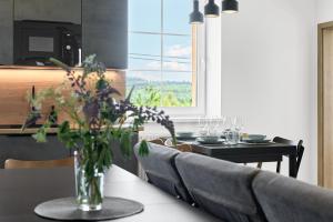 a dining room with a table with a vase of flowers at Rezidence George by Mountain ways in Kovářská