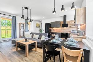 a kitchen and living room with a table and chairs at Rezidence George by Mountain ways in Kovářská