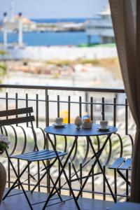 a table and chairs on a balcony with a view at La Zagara Rooms - Porto di Milazzo in Milazzo