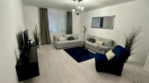a living room with two couches and a tv at PT Residence in Zalaegerszeg