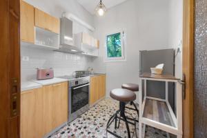 a kitchen with a counter and a stool in it at ChaKo Stay Solutions Studio in Lamía