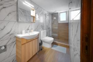 a bathroom with a white sink and a toilet at ChaKo Stay Solutions Studio in Lamía