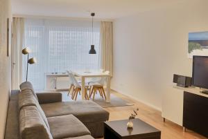 a living room with a couch and a table at Düne, App 9 in Duhnen