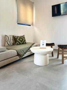 a living room with a couch and a table at Akroyiali Resort in Vasiliki