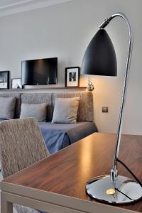 a black lamp sitting on a table in a living room at Hôtel Londres et New York - Teritoria in Paris