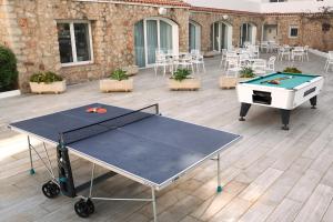 a ping pong table with a ping pong ball on a patio at Hotel Vibra Marco Polo I - Adults only in San Antonio