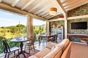 a living room with a couch and tables and a television at Podere il Cavallo Blu in Le Focette