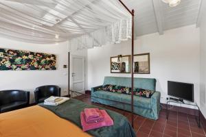 a living room with a bed and a couch at Podere il Cavallo Blu in Le Focette