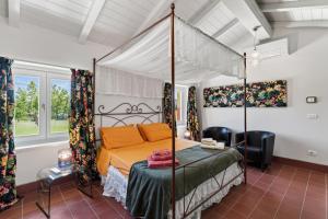 a bedroom with a canopy bed in a room at Podere il Cavallo Blu in Le Focette