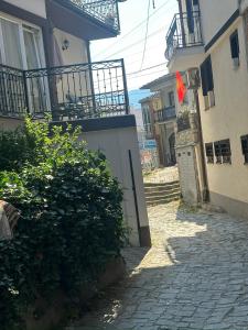 an alley with a building with a gate and a flag at OneRoom in Ohrid