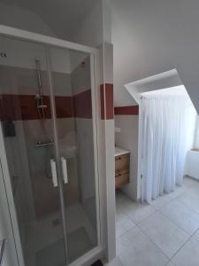 a bathroom with a glass shower in a room at Appart 'Hôtel Le Mondes in Le Pouliguen +12 photos