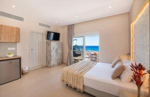 a bedroom with a bed and a view of the ocean at Petra Studios in Palaiochora