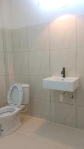 a bathroom with a toilet and a sink at NURBATA HOLDING'S Hostel in Kuta Lombok +20 photos