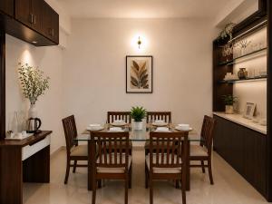 a dining room with a table and chairs at Serene Padmanabham Premium Luxury Apartments Near Sree Padmanabhaswamy Temple in Trivandrum