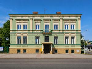 a large green building with a door on a street at Rezydencja Jagiellońska in Sanok +22 photos
