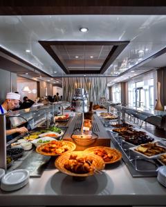 a buffet line with many different types of food at Rénéa Hotel in Sétif +10 photos