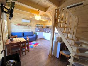 a living room with a blue couch and a staircase at Chata Tisá in Tisá