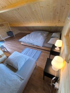 a room with two beds and two lamps in a cabin at Chata Tisá in Tisá
