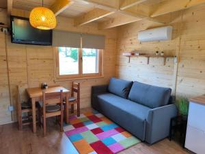 a living room with a couch and a table at Chata Tisá in Tisá