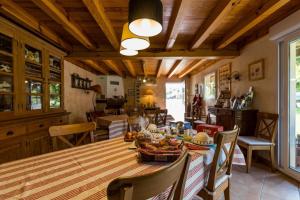 a kitchen and dining room with a table and chairs at L'étable des amis in Escalans