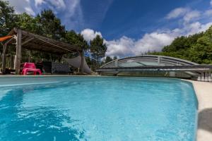 a large swimming pool with a bridge over it at L'étable des amis in Escalans