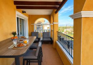 a balcony with a table and chairs on a balcony at Casa suerte in Algorfa
