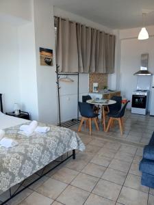 a room with a kitchen and a table and chairs at ANGIRA - Koroni Apartments in Koroni