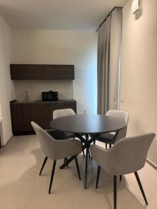 a dining room with a table and chairs at Rooms Residence Rubiera in Rubiera