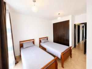 two beds in a room with white walls at Saidia Marina in Saïdia +15 photos