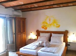a bedroom with a bed with a painting on the wall at Finca Alqueria Fosca in Campos +41 photos