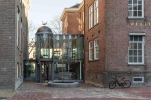 a glass building with a bike parked in front of it at Wittenberg by Cove in Amsterdam
