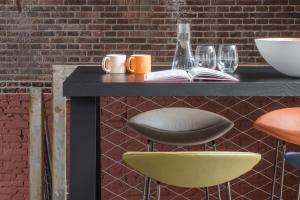 a black table with two chairs and a book at Wittenberg by Cove in Amsterdam
