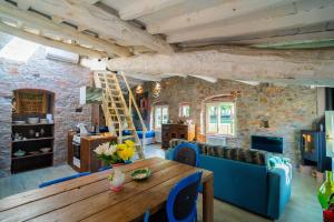 a living room with a wooden table and blue chairs at Inside the Wall in Lucca
