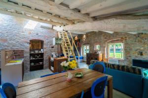 a dining room with a wooden table and blue chairs at Inside the Wall in Lucca