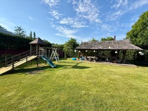 a playground in a yard with a gazebo at Juka in Palanga +4 photos