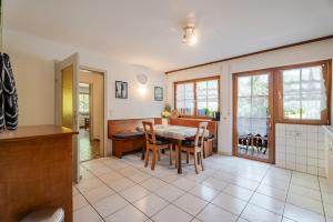 a kitchen and dining room with a table and chairs at Ferienwohnung Bergfranzenhof in Oppenau