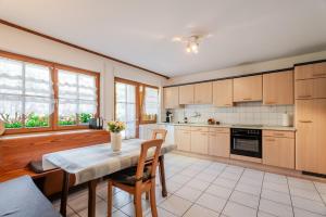 a kitchen with a table and chairs in a room at Ferienwohnung Bergfranzenhof in Oppenau +29 photos