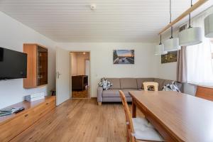 a living room with a couch and a table at Ferienwohnung Bergfranzenhof in Oppenau